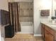 Well-maintained bathroom with tile surround, shower, granite countertops and wooden cabinets at 5449 Festival Ave, Fairburn, GA 30213