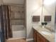 Bathroom featuring a granite countertop vanity and bathtub with decorative tile surround at 5449 Festival Ave, Fairburn, GA 30213