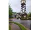 Community clubhouse with a clock tower and lush landscaping at 5449 Festival Ave, Fairburn, GA 30213