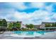 Community pool with lounge chairs and umbrellas surrounded by residential buildings at 5449 Festival Ave, Fairburn, GA 30213