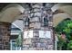 Stone pillar with an 'R' emblem and lantern lighting at 5449 Festival Ave, Fairburn, GA 30213