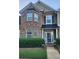 Charming two-story townhouse with brick facade and manicured landscaping at 5449 Festival Ave, Fairburn, GA 30213