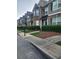 Street view of townhouses with well-kept lawns and uniform landscaping at 5449 Festival Ave, Fairburn, GA 30213
