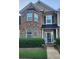 Charming townhome with brick facade, covered porch, and manicured landscaping at 5449 Festival Ave, Fairburn, GA 30213