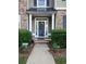 Inviting front entry with brick steps, potted plants, and decorative wreath at 5449 Festival Ave, Fairburn, GA 30213