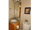 Neat half-bathroom featuring a granite countertop, decorative mirror, and a leafy plant at 5449 Festival Ave, Fairburn, GA 30213