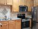 Bright kitchen featuring stainless appliances, granite countertops and stylish tile backsplash at 5449 Festival Ave, Fairburn, GA 30213