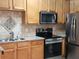 Close-up of kitchen with stainless steel appliances, including a microwave, oven, and fridge at 5449 Festival Ave, Fairburn, GA 30213