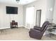 Relaxing living room featuring a plush recliner and a view of a mounted television at 5449 Festival Ave, Fairburn, GA 30213