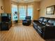 Cozy living room with leather furniture, wood-look tile, and natural light at 5449 Festival Ave, Fairburn, GA 30213