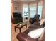 Comfortable living room with a brown leather sofa, recliner, and bright windows at 5449 Festival Ave, Fairburn, GA 30213
