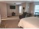 Spacious main bedroom with a recliner, TV, and bright windows, offering a relaxing retreat at 5449 Festival Ave, Fairburn, GA 30213