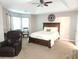 Spacious main bedroom featuring a trey ceiling, a cozy seating area, and great natural light at 5449 Festival Ave, Fairburn, GA 30213