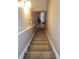 Carpeted stairway leading into the home with a neutral color palette at 5449 Festival Ave, Fairburn, GA 30213