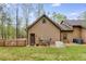 Cozy home exterior with a well-maintained lawn, generator, and wooden privacy fence at 575 W Wayside Rd, Carrollton, GA 30116