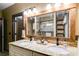 Bathroom with double vanity, farmhouse mirror, shower with glass door, and tiled backsplash at 575 W Wayside Rd, Carrollton, GA 30116