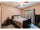 Cozy bedroom with a ceiling fan, natural light from the window, and neutral colored walls at 575 W Wayside Rd, Carrollton, GA 30116