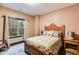 Bright bedroom with large window, wood frame bed, and carpet at 575 W Wayside Rd, Carrollton, GA 30116