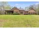 Charming single-story home with stone accents, lush landscaping, and a well-manicured front lawn at 575 W Wayside Rd, Carrollton, GA 30116