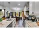 Bright kitchen featuring white cabinets, stone counters, and eat-in dining area at 575 W Wayside Rd, Carrollton, GA 30116