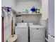 Functional laundry room with shelving, washer, and dryer at 575 W Wayside Rd, Carrollton, GA 30116