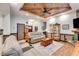 Open-concept living space with wood-look floors and a stone fireplace at 575 W Wayside Rd, Carrollton, GA 30116