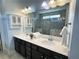 Bright bathroom featuring a double vanity, custom cabinets, and a glass-enclosed tiled shower at 5990 Arbor Green Cir, Sugar Hill, GA 30518