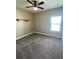 Cozy bedroom with plush carpeting and natural light from a window at 5990 Arbor Green Cir, Sugar Hill, GA 30518