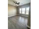 Spacious bedroom with a large window and wood-look vinyl flooring at 5990 Arbor Green Cir, Sugar Hill, GA 30518