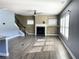 Open living area features a fireplace, hardwood floors, a ceiling fan, and windows providing natural light at 5990 Arbor Green Cir, Sugar Hill, GA 30518