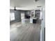 Spacious living area connects to the kitchen and features hardwood floors and modern finishes at 5990 Arbor Green Cir, Sugar Hill, GA 30518