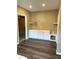 Versatile room with vinyl flooring and built-in cabinets with open shelving at 5990 Arbor Green Cir, Sugar Hill, GA 30518