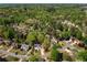 Expansive aerial view of the real estate with lush green trees and well-maintained neighborhood at 125 Ketton Xing, Johns Creek, GA 30097