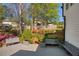 Serene backyard featuring a wooden deck with seating, lush landscaping, and mature trees for outdoor enjoyment at 125 Ketton Xing, Johns Creek, GA 30097