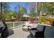 Lovely backyard deck with comfortable seating, beautiful landscaping, and an outdoor grill for entertaining at 125 Ketton Xing, Johns Creek, GA 30097