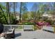 Expansive backyard deck featuring serene views, comfortable seating, and lush landscaping, ideal for outdoor enjoyment at 125 Ketton Xing, Johns Creek, GA 30097