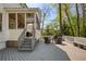 Well-appointed backyard deck featuring an outdoor kitchen, screened porch access, and a cozy seating area at 125 Ketton Xing, Johns Creek, GA 30097