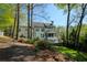 Picturesque backyard featuring a well-maintained lawn, beautiful trees, and a glimpse of the home's design at 125 Ketton Xing, Johns Creek, GA 30097
