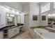 Elegant bathroom showcasing a soaking tub, granite countertops, and custom cabinets at 125 Ketton Xing, Johns Creek, GA 30097