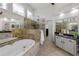 Elegant bathroom featuring a soaking tub, glass-enclosed shower, and granite countertops at 125 Ketton Xing, Johns Creek, GA 30097