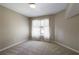 Cozy bedroom features soft carpeting and bright window with sheer curtains creates a relaxing atmosphere at 125 Ketton Xing, Johns Creek, GA 30097