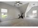 Bright bonus room with large windows, plush carpeting, and a contemporary ceiling fan offers a flex space at 125 Ketton Xing, Johns Creek, GA 30097