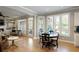 Bright dining area featuring hardwood floors, large windows, and an elegant round table at 125 Ketton Xing, Johns Creek, GA 30097