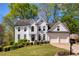 Beautiful white brick two-story home with a well-manicured lawn and a two-car garage at 125 Ketton Xing, Johns Creek, GA 30097