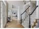 Entryway featuring hardwood floors, staircase, and a view into the office space at 125 Ketton Xing, Johns Creek, GA 30097