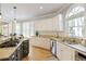 Stylish kitchen with stainless steel appliances, granite counters, and a cozy breakfast area with plenty of natural light at 125 Ketton Xing, Johns Creek, GA 30097