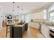 Elegant kitchen featuring granite countertops, stainless steel appliances, and an island cooktop with seating at 125 Ketton Xing, Johns Creek, GA 30097