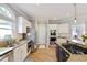 Modern kitchen with stainless steel appliances, a center island with a cooktop, and custom white cabinets at 125 Ketton Xing, Johns Creek, GA 30097