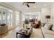 Open-concept living room with hardwood floors, fireplace, and view of the kitchen and dining area at 125 Ketton Xing, Johns Creek, GA 30097