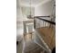 Carpeted staircase leading to the foyer with a chandelier and hardwood flooring visible at 125 Ketton Xing, Johns Creek, GA 30097